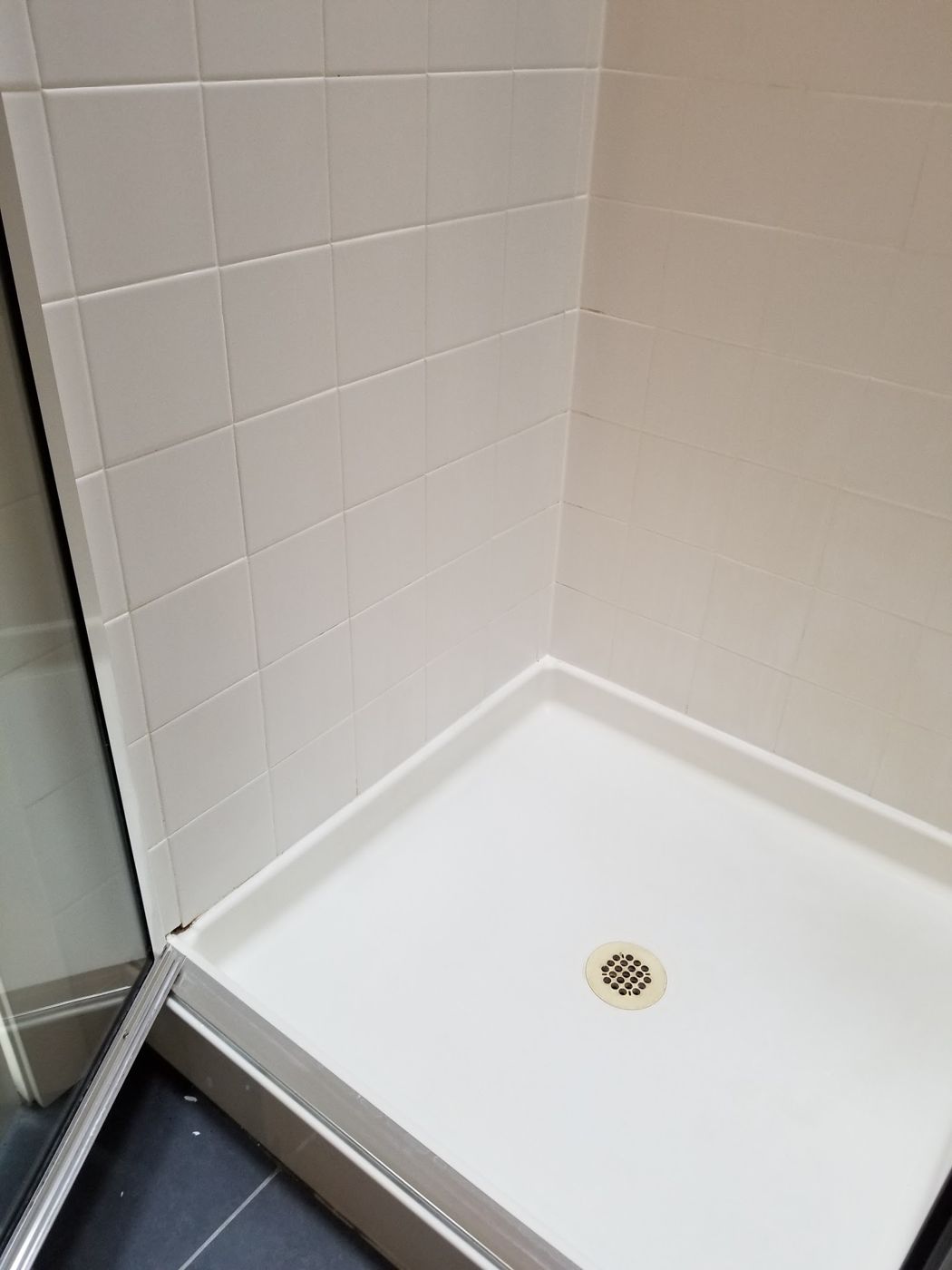 Spotless white shower pan and tile corner